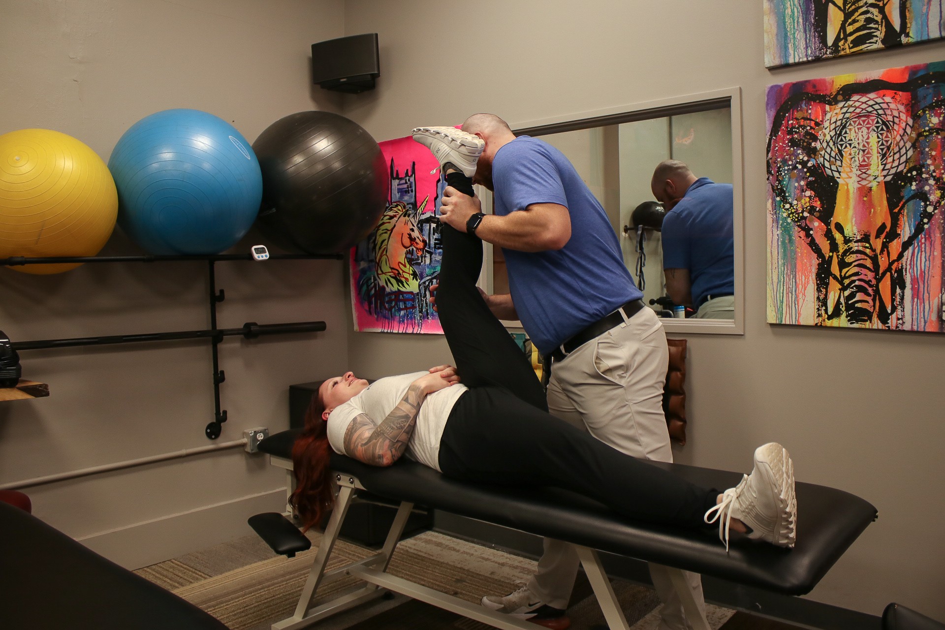 Chiropractor examining patient with back pain at Pittsburgh Physical Medicine
