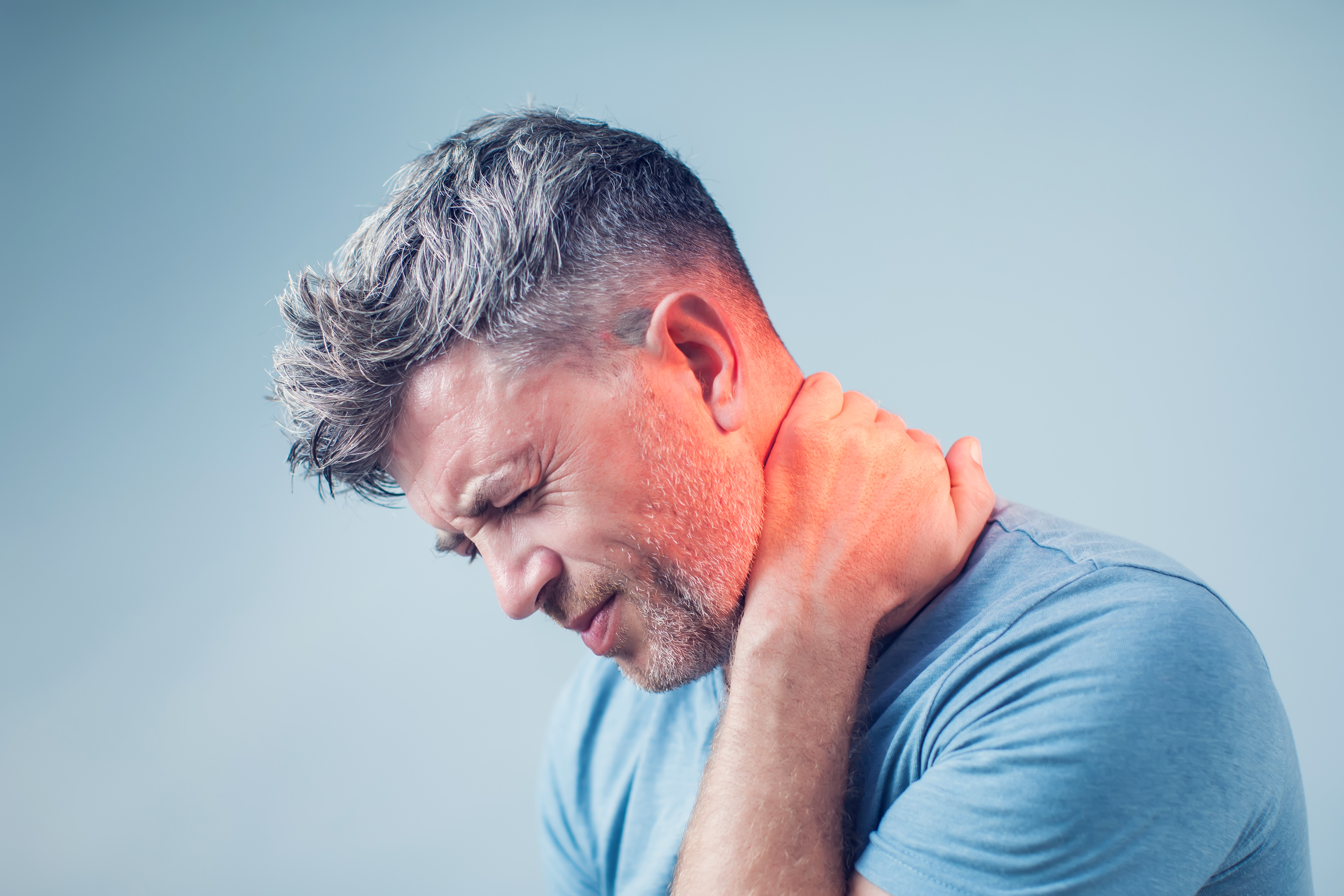 Person holding neck in pain — neck pain chiropractic treatment Pittsburgh PA